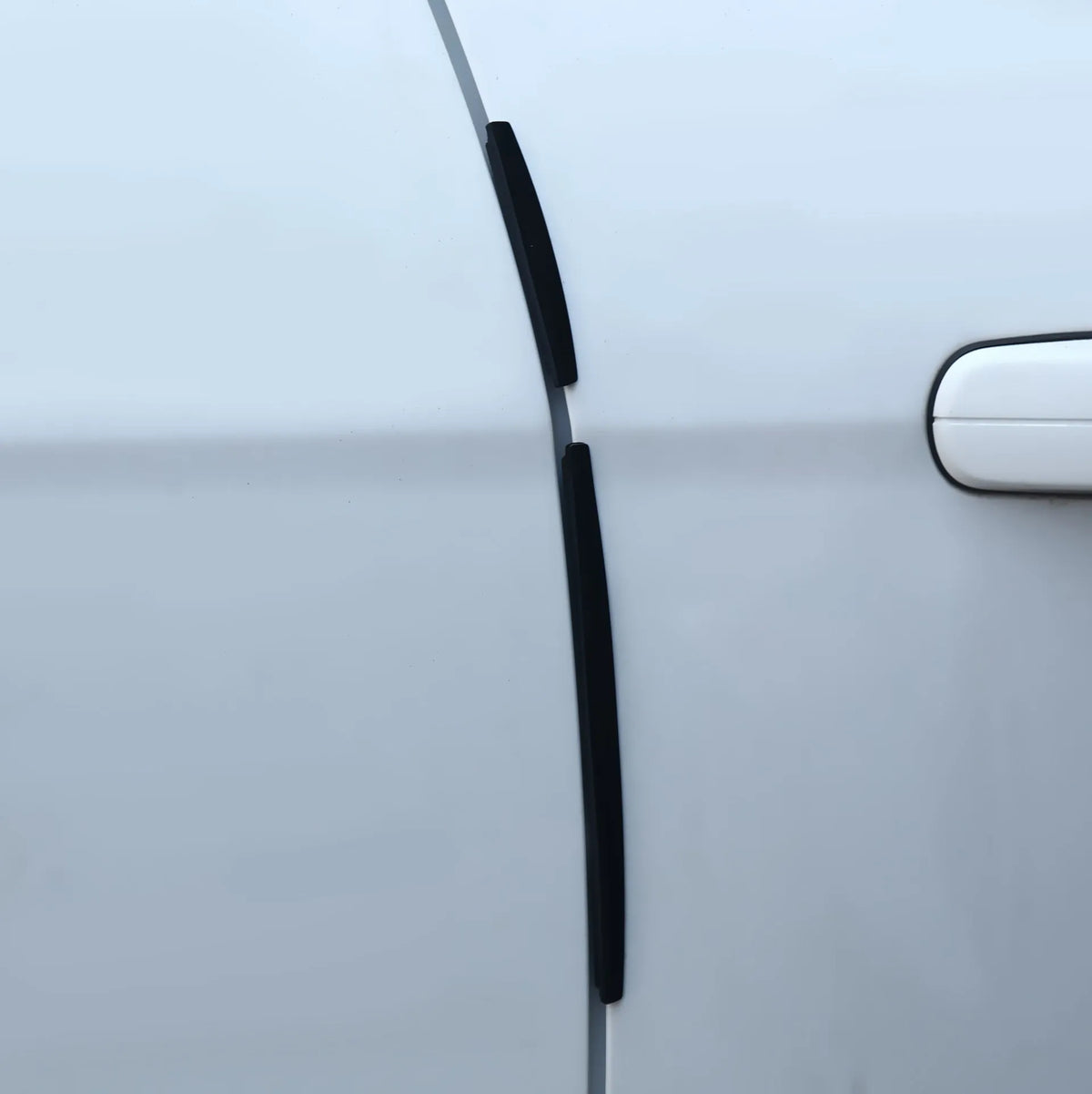White plastic car door edge protector strip, 1 metre long with adhesive backing.
