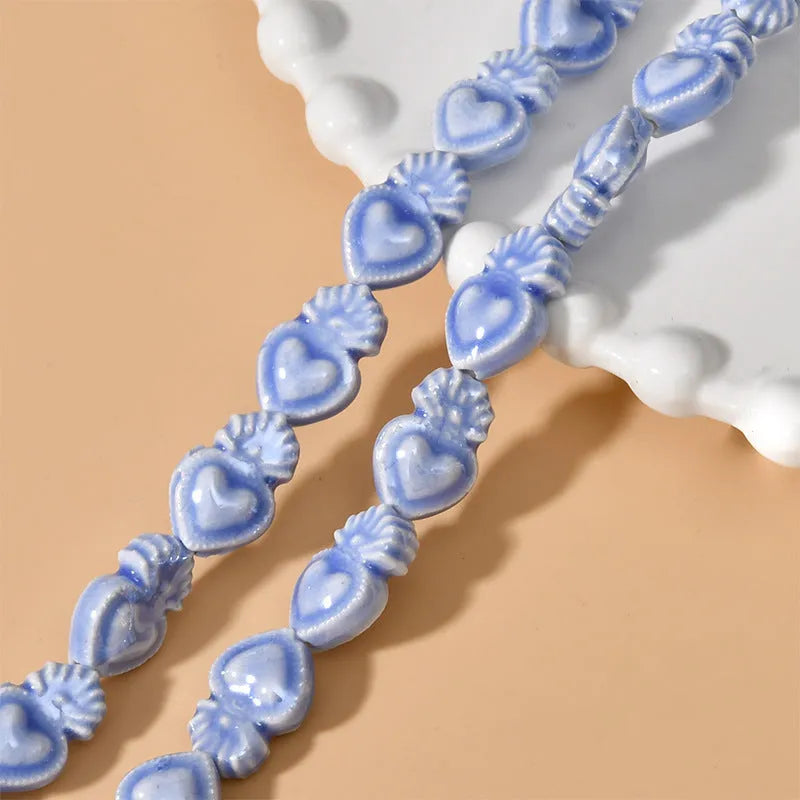 Love heart shaped torch ceramic beads in various colours including cream white, pinks, blues and greens for jewellery making