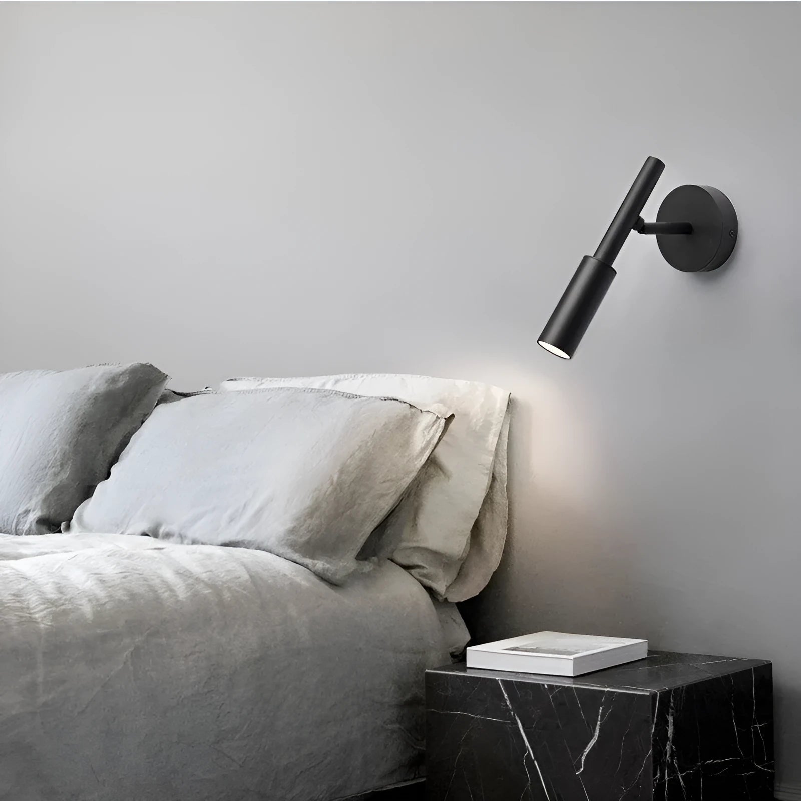 Modern cylindrical wrought iron wall lamp in black or white with three colour light settings.