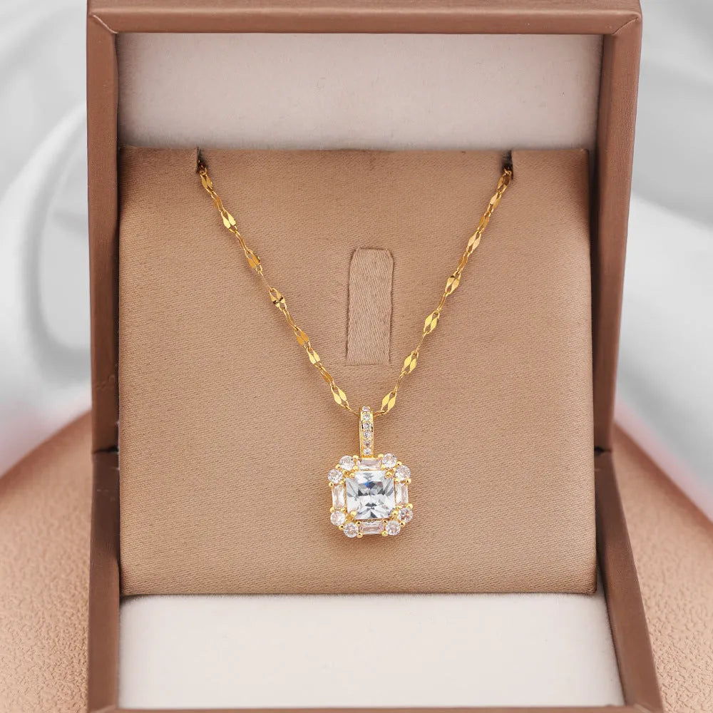Gold geometric zircon inlaid pendant on a water wave chain necklace.
