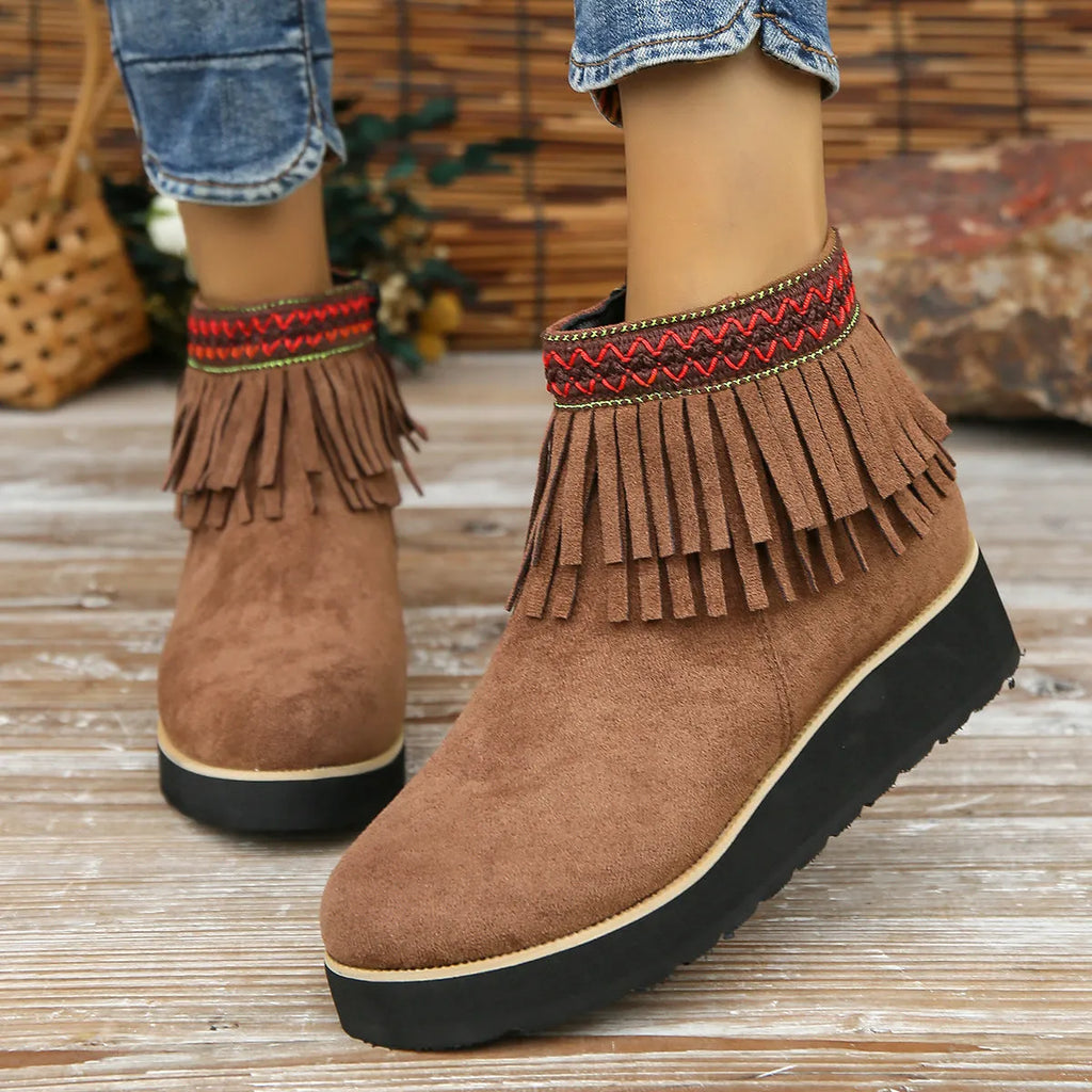 Women's dark brown suede ankle boots with thick platform wedge sole, side zip, and tassel detail.