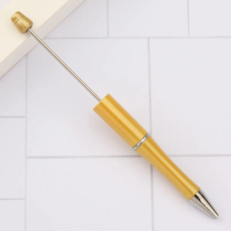 Ballpoint pen with colourful spinning plastic beads on barrel, shown in a gradient purple finish.