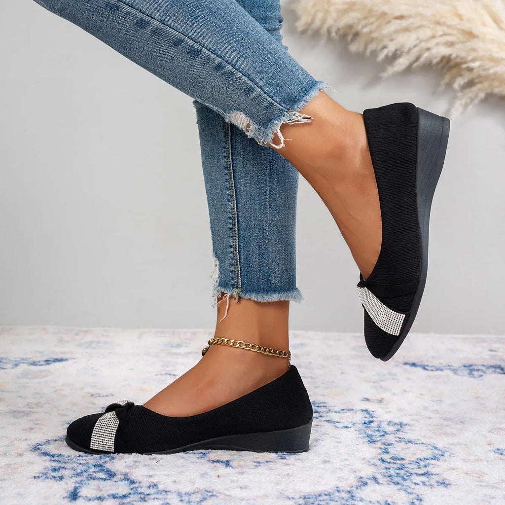 Black women's slip-on casual shoes with rhinestones on the fabric upper and a chunky heel.
