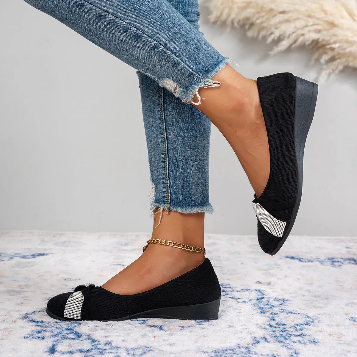 Black women's slip-on casual shoes with rhinestones on the fabric upper and a chunky heel.