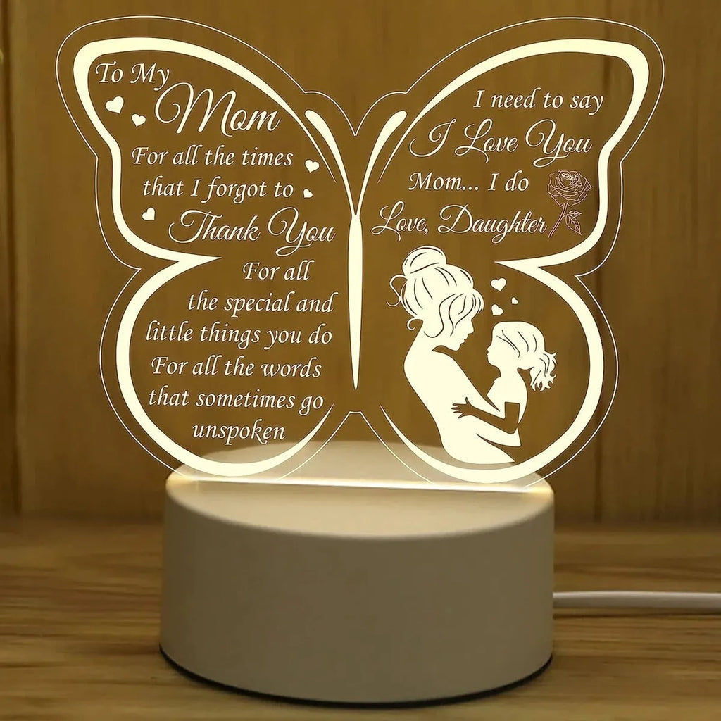 A white heart-shaped table lamp with a touch-sensitive base and a USB cable.