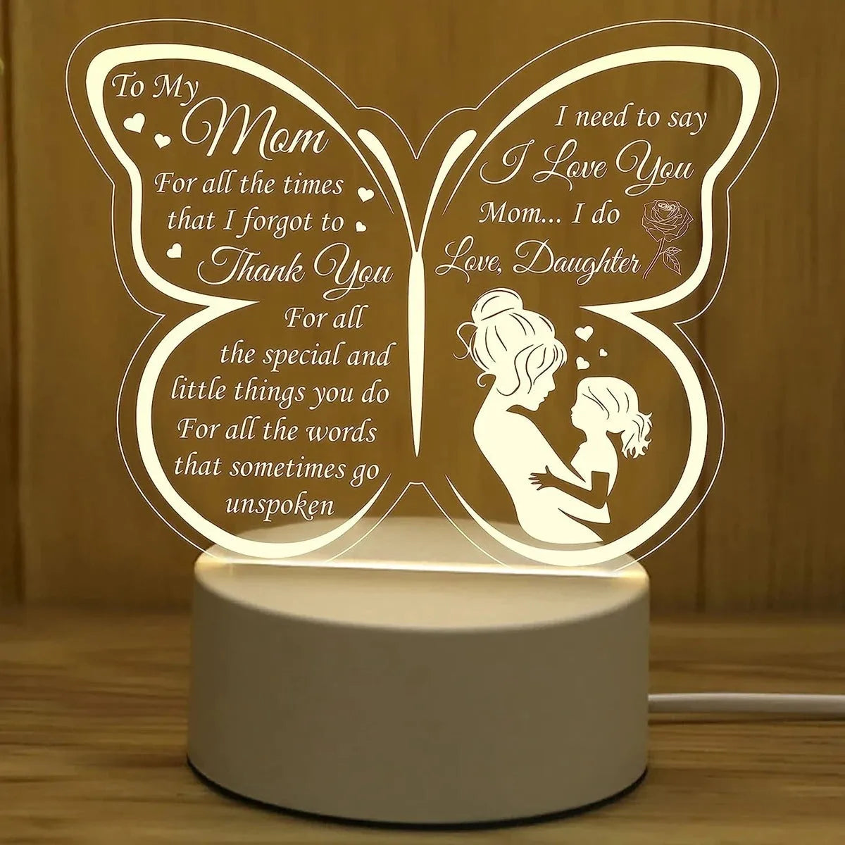 A white heart-shaped table lamp with a touch-sensitive base and a USB cable.