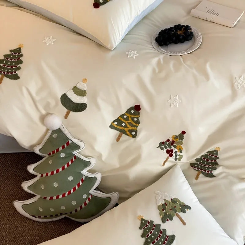 Cream Blue cotton duvet cover with embroidered Christmas tree and flower design, part of a four-piece bedding set.