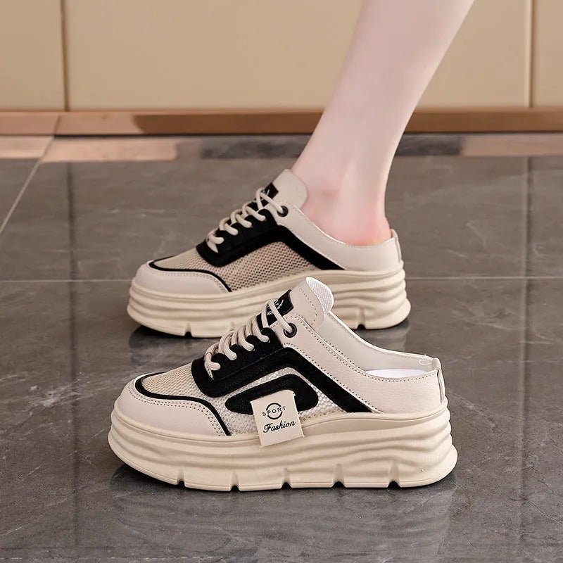 Women's black mesh half slippers with a round toe and rubber sole, shown on a white background.