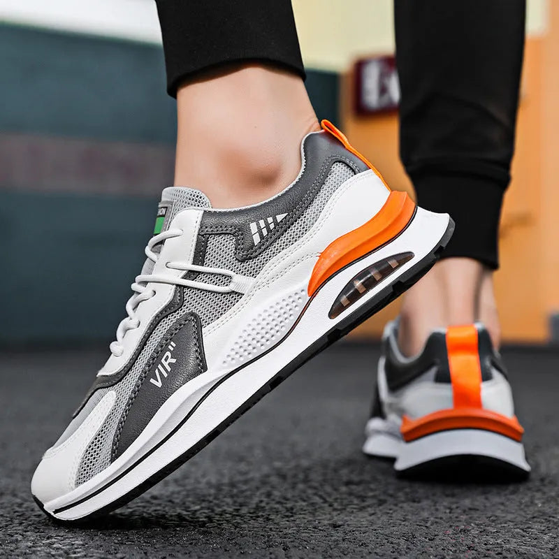 Men's grey mesh running shoes with mid-top height and rounded toe design on white background