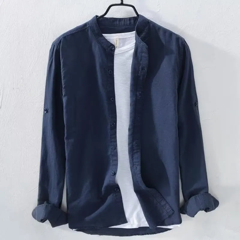 Man wearing a loose-fitting light blue long sleeve casual shirt made from cotton linen blend.
