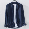 Man wearing a loose-fitting light blue long sleeve casual shirt made from cotton linen blend.