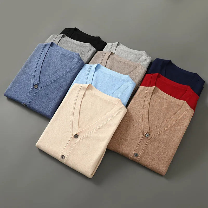 Man wearing a dark blue V-neck Andy velvet knitted cardigan with long sleeves.