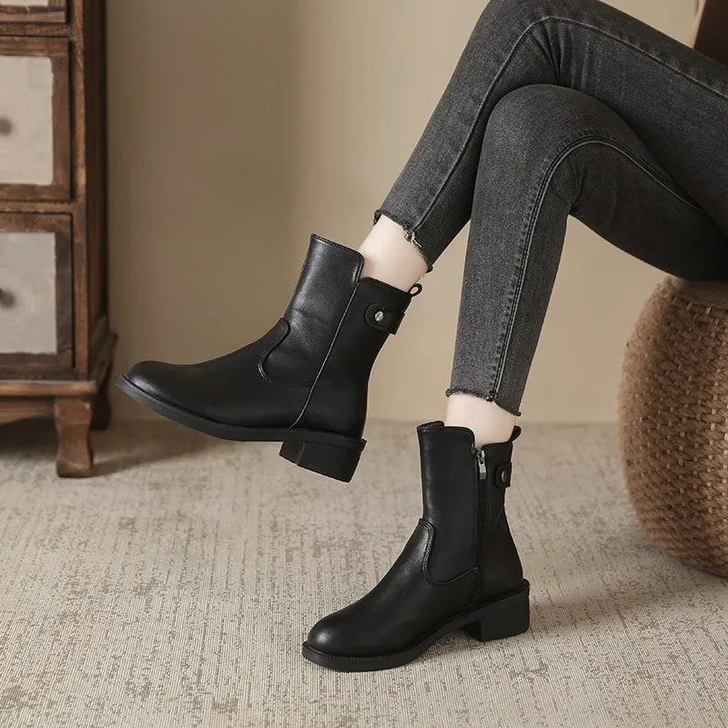 Black women's ankle boots with a side zip and round toe on a low heel.