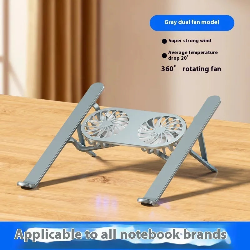 Silver aluminium folding laptop stand with twin cooling fans deployed on a desk.