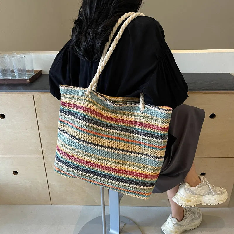 Blue woven shoulder bag with straw-effect pattern, large capacity design with single shoulder strap