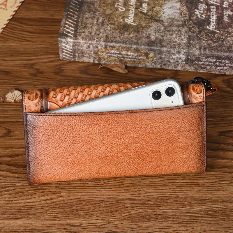 Women's brown embossed floral pattern tri-fold cowhide leather wallet showing interior compartments