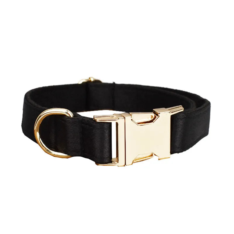 A cloth dog collar, matching leash, decorative bow, and dog vest set laid out flat, showing the coordinated design.