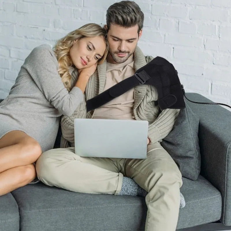 Grey electric heating shoulder pad with micro-USB cable for 5V power connection.