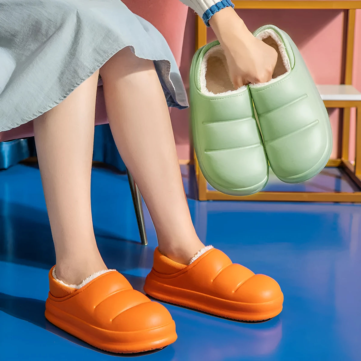 A pair of waterproof EVA couple slippers with a warm plush lining, shown in a green colour option.