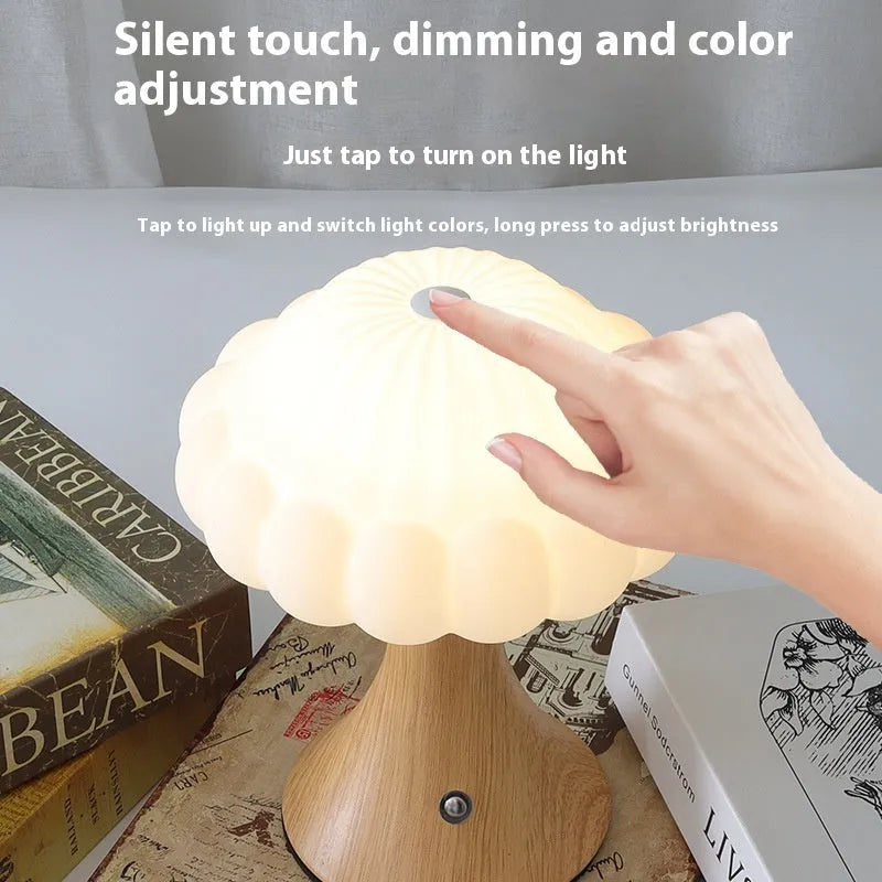 Mushroom-shaped charging touch night light in five colour options on wooden table