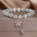 Women's white cat's eye crystal bracelet with flower tassels and morganite safety buckle pendant