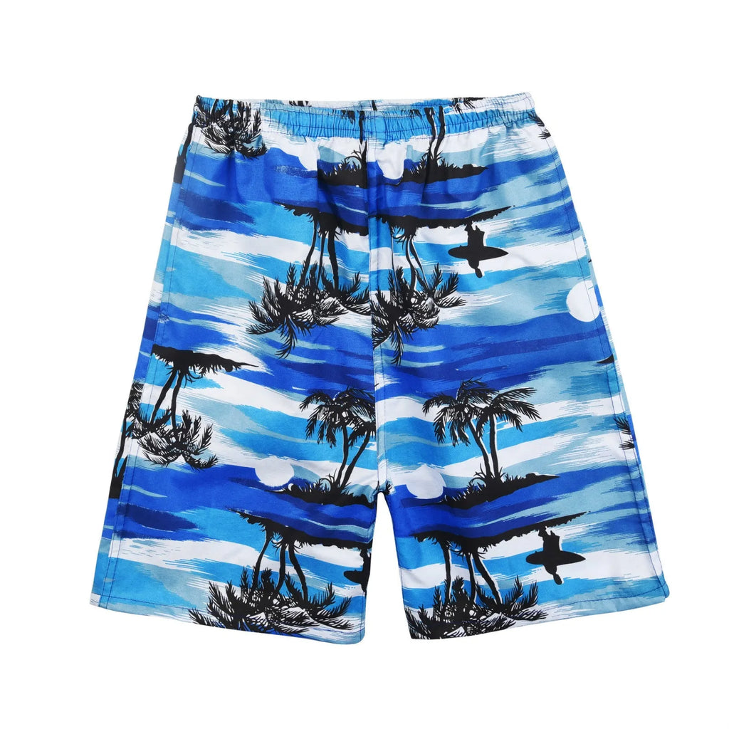 Man wearing floral print swimming trunks at the beach, showing the loose fit and colourful pattern.