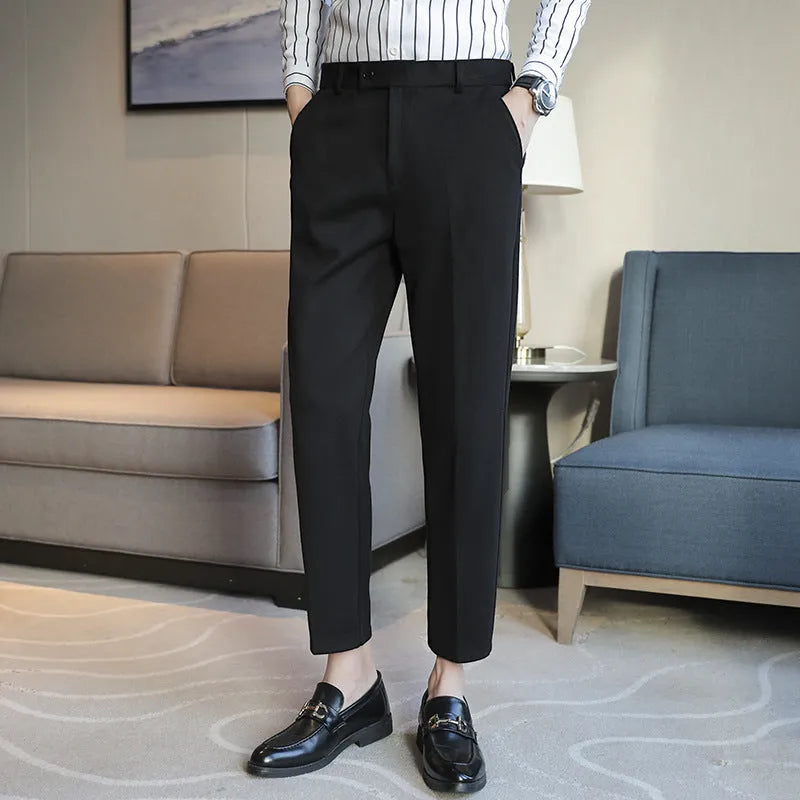Straight leg brown corduroy trousers for men laid flat, showing texture and elastic waistband.