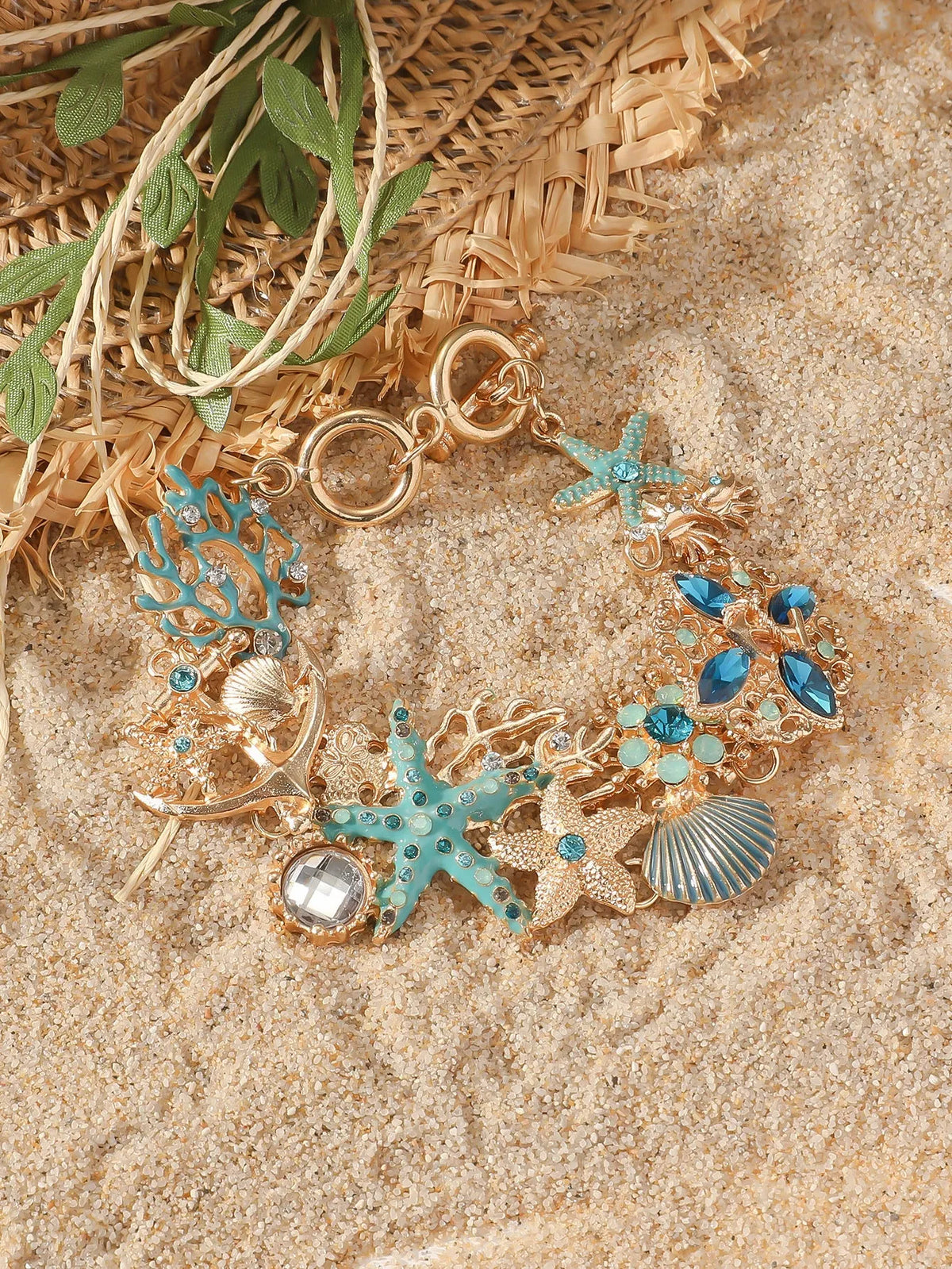 Women's alloy marine bracelet with boat anchor and starfish charms in turquoise, red, or blue coral colours.