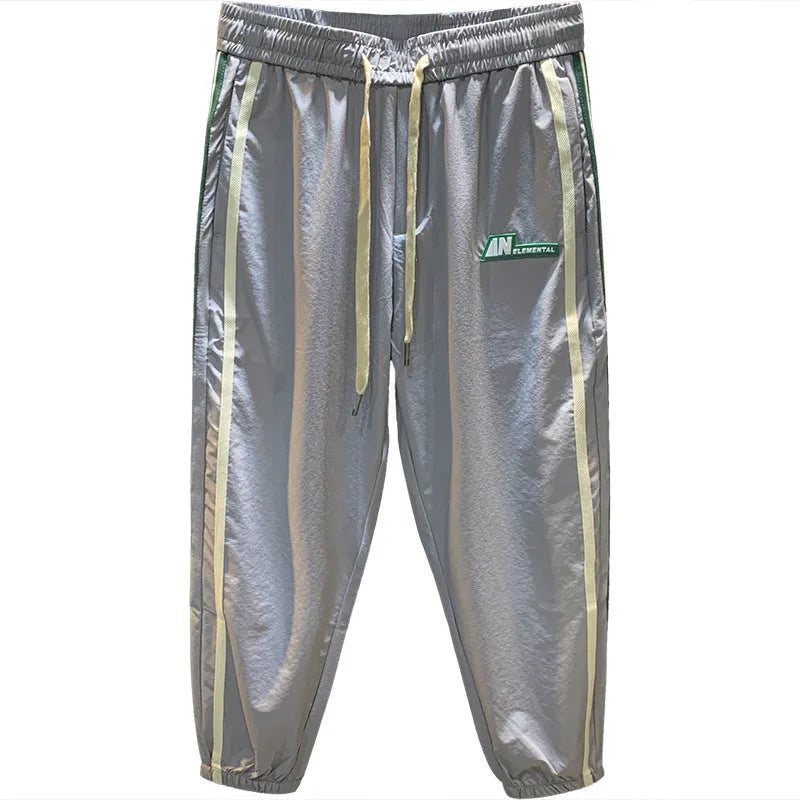 Men's black ice silk harem pants with elastic waistband and tapered leg design