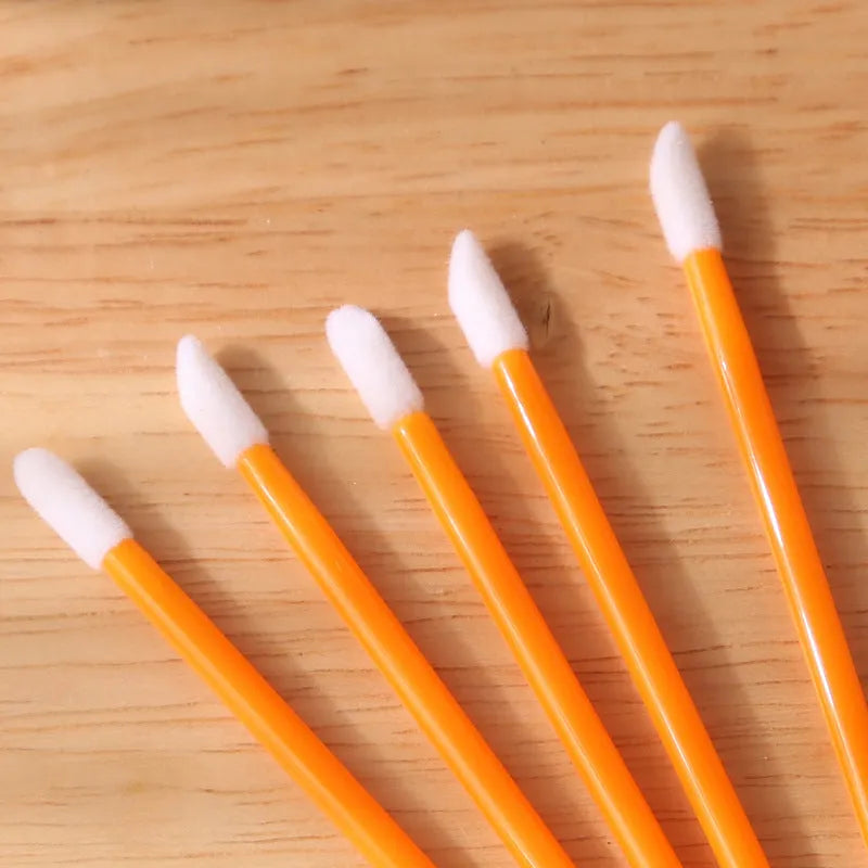 Pack of multi-colour disposable lip brush applicators with black handles and soft flocked tips.