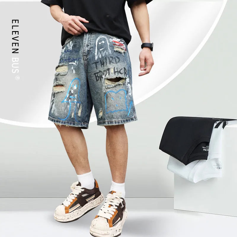 Blue denim shorts for men with ripped knees and graffiti print, featuring a straight leg and a zipper fly