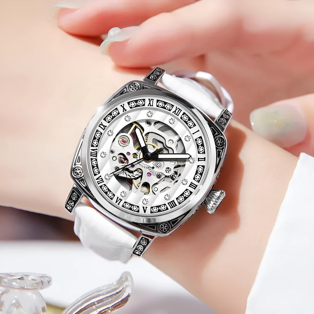 Leather strap mechanical wristwatch with luminous hands on a black dial.