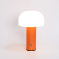 USB-powered plastic table lamp with integrated charging port in black, green, orange, or white.