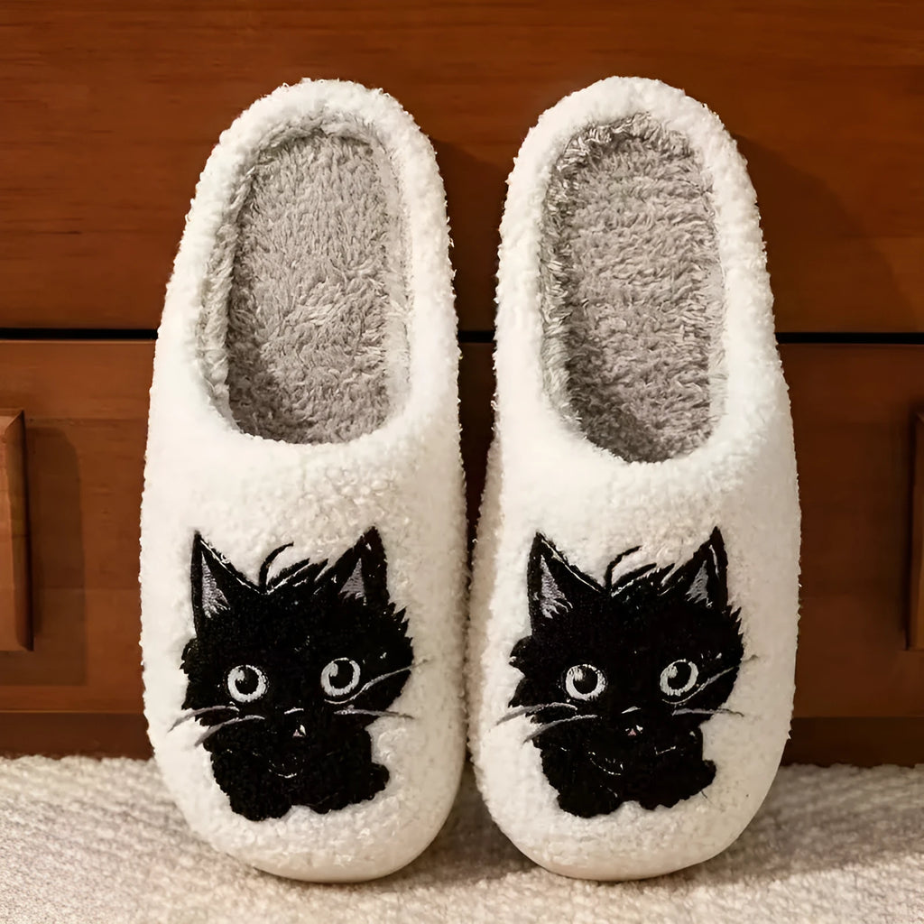 White plush slippers with Black Beard Cat cartoon couple pattern, velvet lining, and a textured non-slip sole.