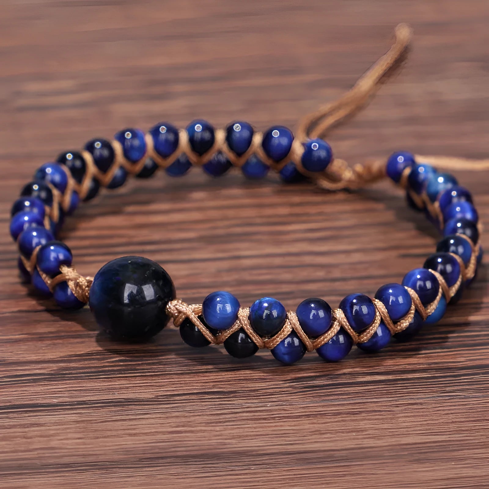 Handwoven geometric pull bracelet with blue tiger eye stone beads.