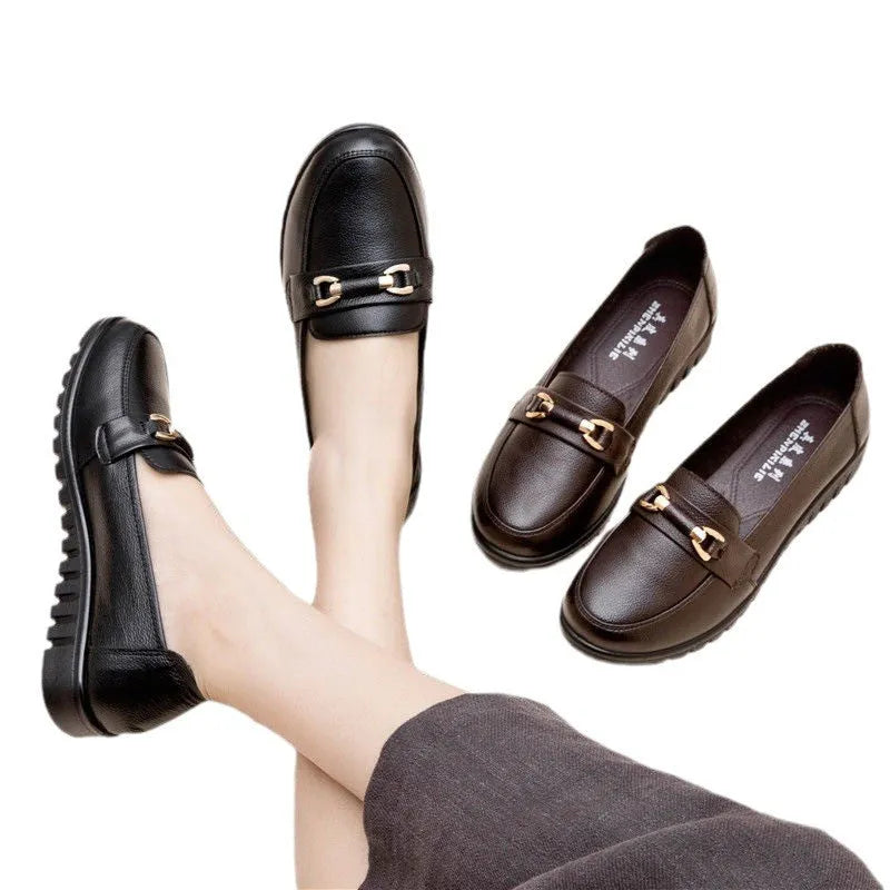 Black casual leather pumps with a soft rubber sole and low flat heel on a white background