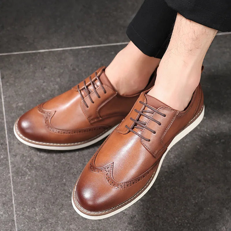 Men's black and brown slip-on business casual shoes with round toe and carved detailing