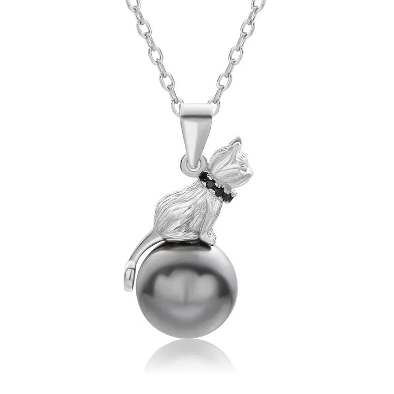 Close-up of a sterling silver cat pendant necklace on a clavicle chain.