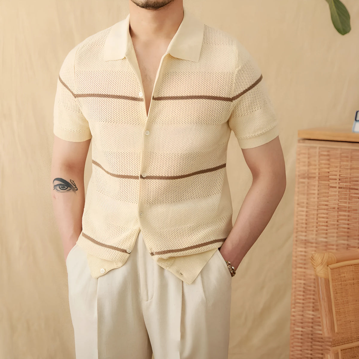 Camel coloured lapel collar short sleeve knitted cardigan on a hanger