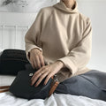 Women's loose fit solid colour long sleeve top with a half-high neck, shown in white.