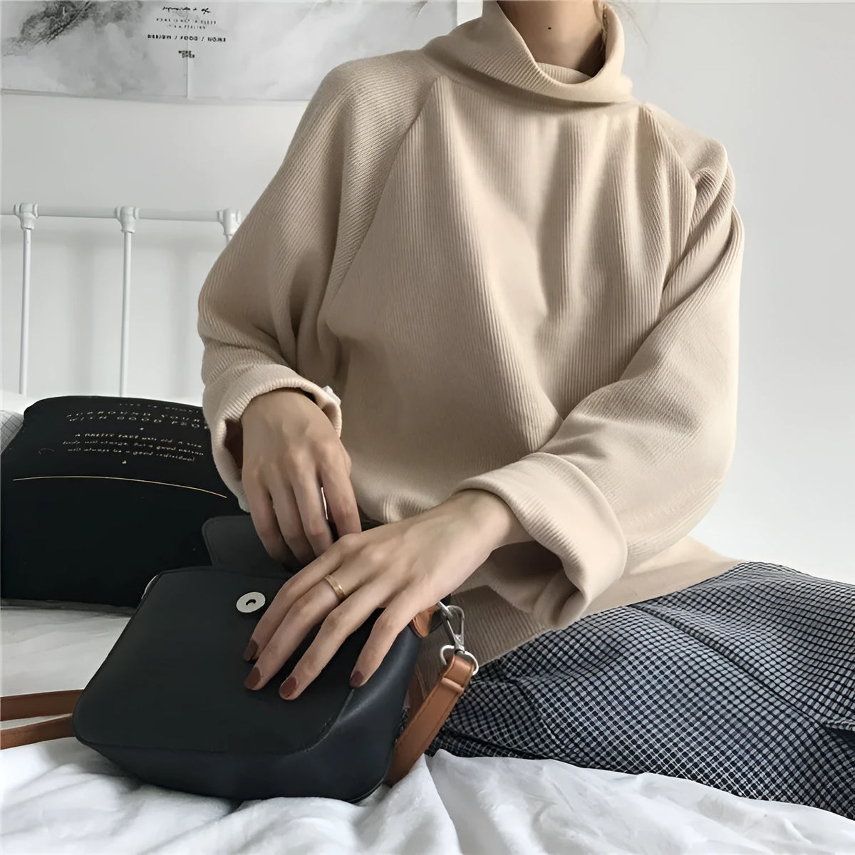 Women's loose fit solid colour long sleeve top with a half-high neck, shown in white.