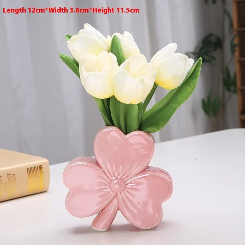 Clover-shaped white porcelain vase in European style on a desktop.