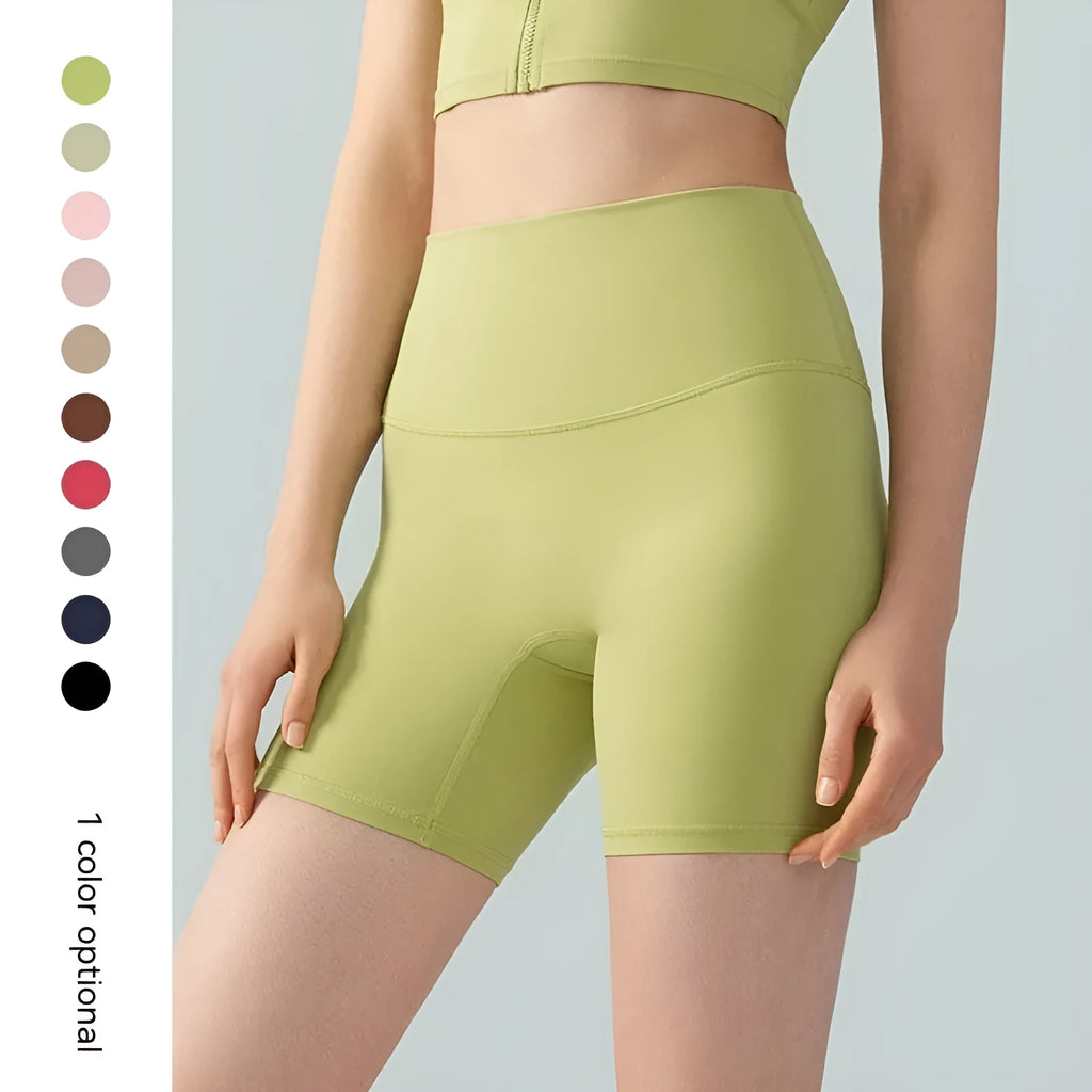 Women's leaf green high waist Lycra yoga shorts with four-point construction on a fitness background.