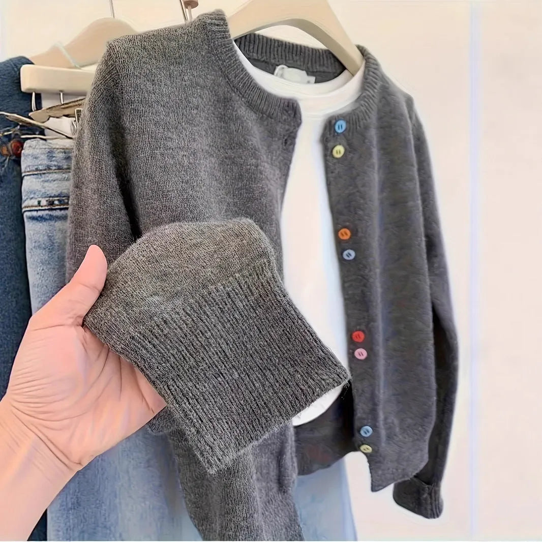 Dark grey women's button-front cardigan sweater with long sleeves on a hanger.