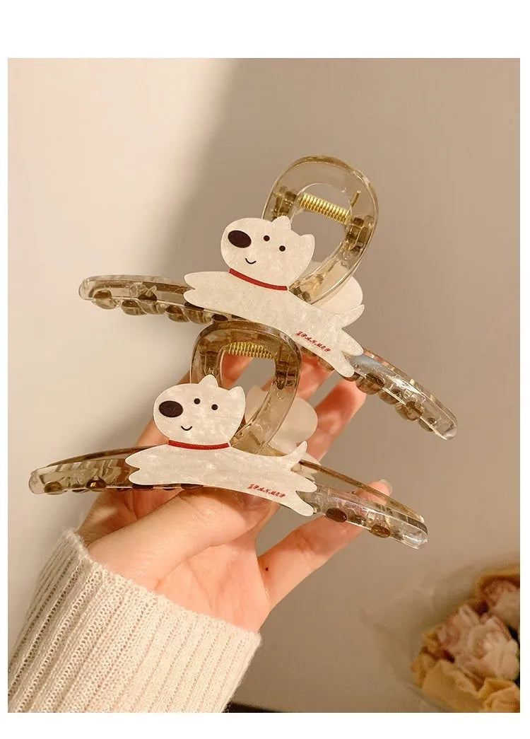 Beige and brown cartoon puppy hair grip barrettes on white background