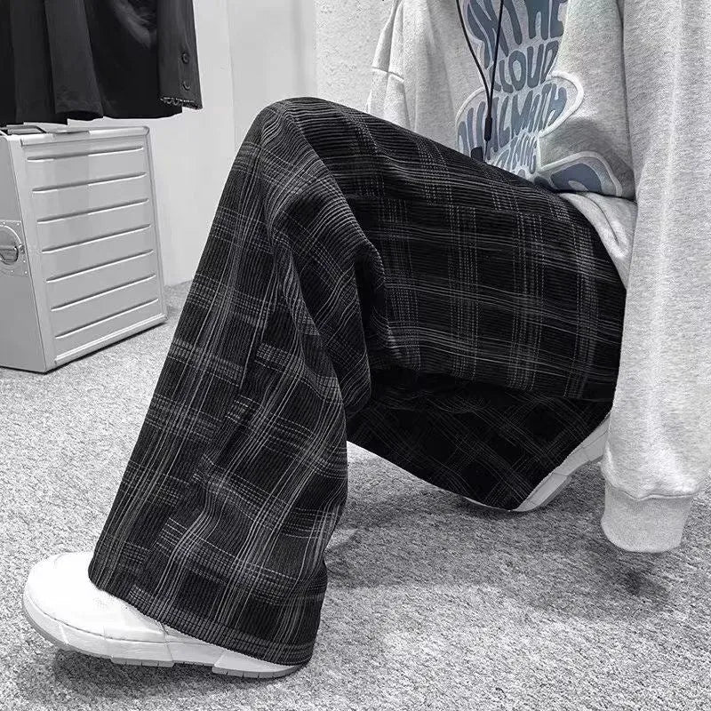 Man wearing black plaid retro loose-fit straight-leg casual trousers.