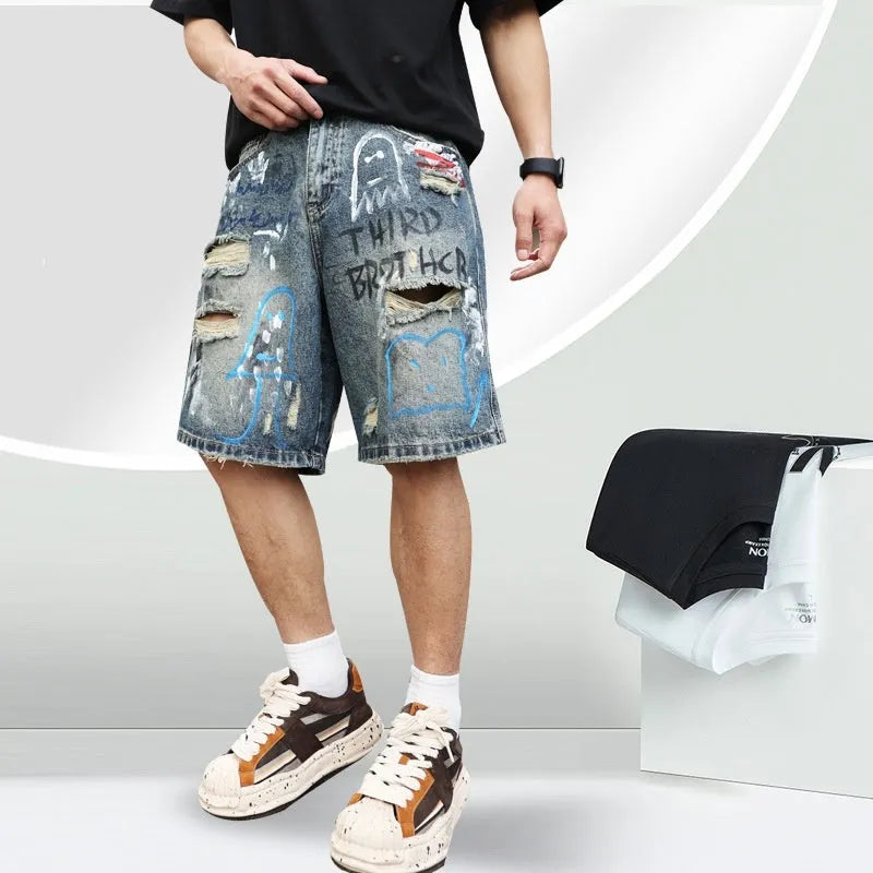 Blue denim shorts for men with ripped knees and graffiti print, featuring a straight leg and a zipper fly