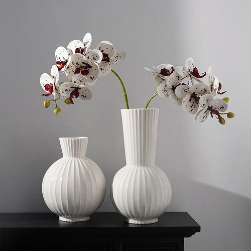 White ceramic ball striped vase in American country style on table with orchid arrangement