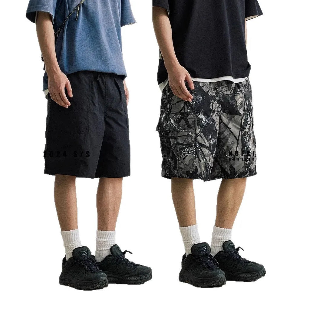 Loose fit straight-leg denim shorts in black shown on a hanger.
