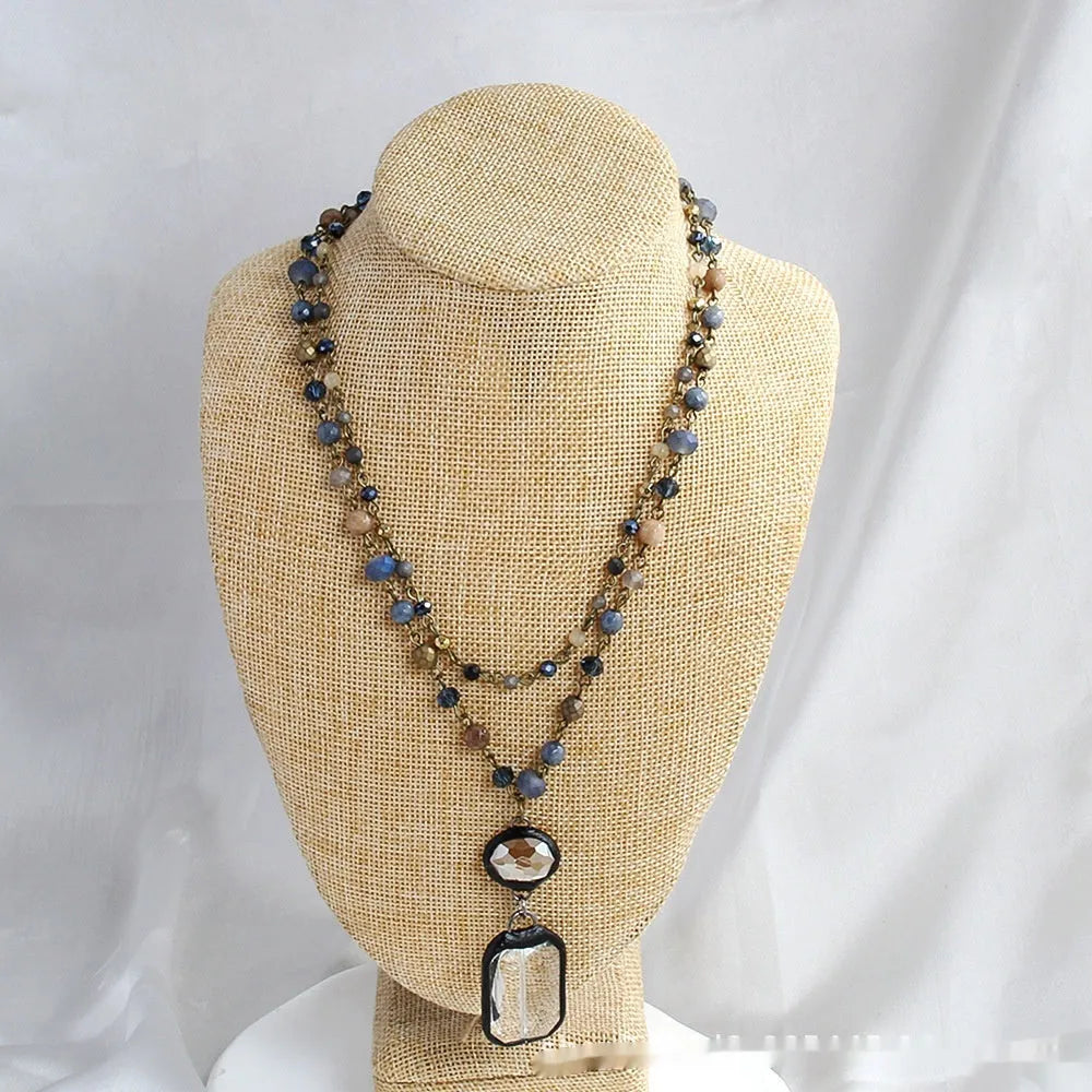 Two-layer tribal-style chain necklace with glass pendant and stone elements in beige and blue colour options